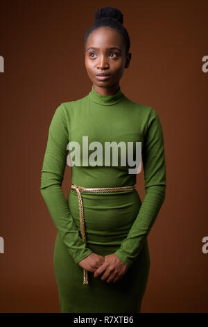 Young beautiful African Zulu businesswoman thinking and looking up Stock Photo