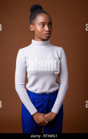 Portrait of young beautiful African Zulu businesswoman thinking Stock Photo