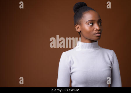 Portrait of young beautiful African Zulu businesswoman thinking Stock Photo