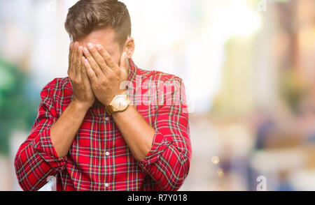 Young handsome man over isolated background with sad expression covering face with hands while crying. Depression concept. Stock Photo