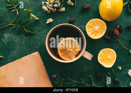 Herbal medicine flat lay top view with cup of hot rose hip tea and slice of lemon Stock Photo