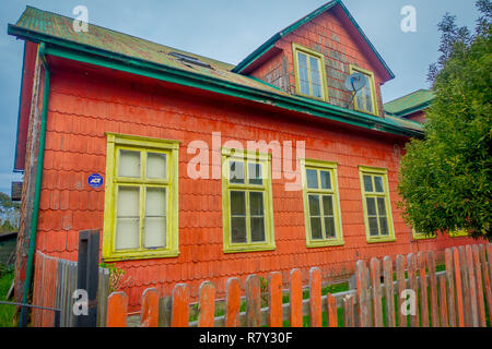 PUERTO VARAS, CHILE, SEPTEMBER, 23, 2018: Outdoor view of orange wooden house building with yellow windows located in Puerto Varas in Chile Stock Photo