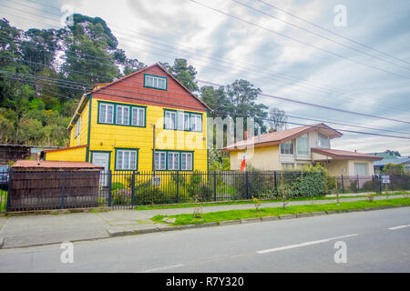 PUERTO VARAS, CHILE, SEPTEMBER, 23, 2018: Outdoor view of yellow wooden house building located in Puerto Varas in Chile Stock Photo