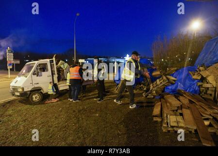 December 04, 2018 - Saint-Amand-Montrond, France: Yellow Vests gather at the Orval roundabout to protest against French President Emmanuel Macron's policies. Protesters have been occupying this roundabout and setting up temporary traffic blockades since the first yellow vest action on November 17. They listened to the French Prime Minister's decision to suspend the fuel tax hike that triggered their protest but immediately vowed to keep on protesting until the government does more to reduce fiscal inequalities and improve their conditions. Stock Photo