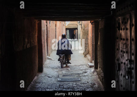 05-03-15, Marrakech, Morocco. A man riding his scooter through the narrow streets and alleys of the old medina. Photo: © Simon Grosset Stock Photo