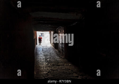 05-03-15, Marrakech, Morocco. A man riding his scooter through the narrow streets and alleys of the old medina. Photo: © Simon Grosset Stock Photo