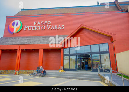 PUERTO VARAS, CHILE, SEPTEMBER, 23, 2018: Group of friends at the enter of paseo Puerto Varas, huge orange wooden building Chile, South America Stock Photo