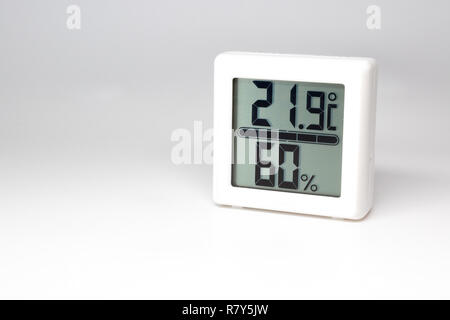 Digital device measuring temperature and humidity. Thermometer and hygrometer. Celsius and percent. Stock Photo