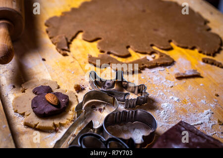 Close up on gingerbread dough and forms, cutters on the wooden table Stock Photo