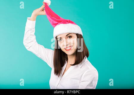 New Year theme Christmas winter holidays office of company employees. portrait young caucasian woman businessman white shirt in funny santa claus hat  Stock Photo