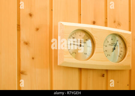 Interior of the sauna. Measurement of humidity and temperature by thermometer and hygrometer. Health safety Stock Photo