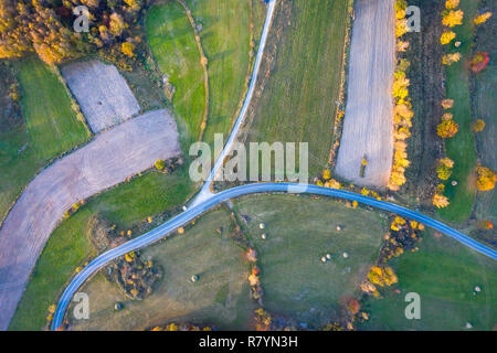 Aerial picture of a countryside village road. Drone shot of agricultural fields, forest. Transylvania, Romania Stock Photo