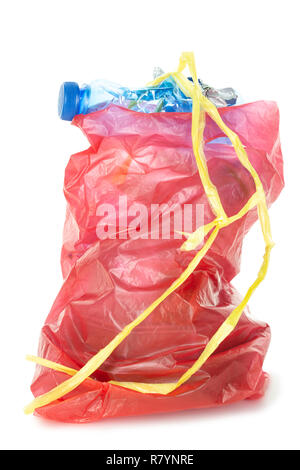 Red plastic garbage bag with stick out empty plastic bottle and other rubbish isolated on white background Stock Photo