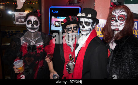 Two couples celebrating Halloween with 'Day of the Dead' 'Dia de Los Muertos' ghoulish face make up and costumes. Cumberland Wisconsin WI USA Stock Photo