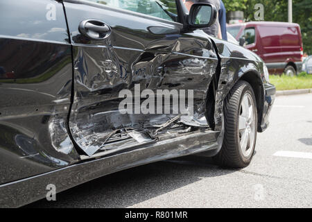 damaged passenger door of black car