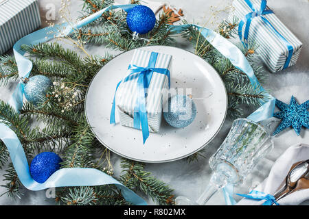 Beautiful Christmas table setting with decorations. Preparation for christmas dinner. Stock Photo