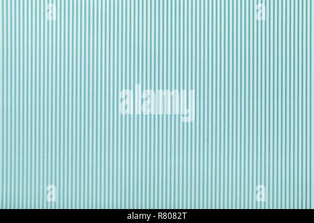 Texture of corrugated light blue paper, macro. Striped pattern of turquoise cardboard background, closeup. Stock Photo