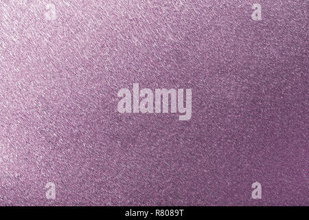 Textural of violet foil background of wavy corrugated paper, closeup. Structure of metallic wrinkled crepe dark purple cardboard macro. Stock Photo