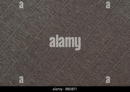 Textural of bronze background of wavy corrugated paper, closeup. Structure of wrinkled crepe dark brown cardboard macro. Stock Photo