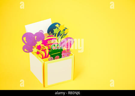 Happy birthday handcraft pop -up greeting card made of paper. Bright postcard with 3D paper figure of giftbox with birthday cake, presents, balloons,  Stock Photo