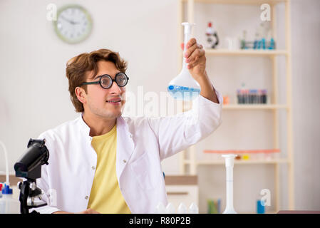 Funny crazy chemist doing experiments and tests Stock Photo