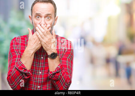 Middle age hoary senior man over isolated background shocked covering mouth with hands for mistake. Secret concept. Stock Photo