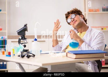 Funny crazy chemist doing experiments and tests Stock Photo