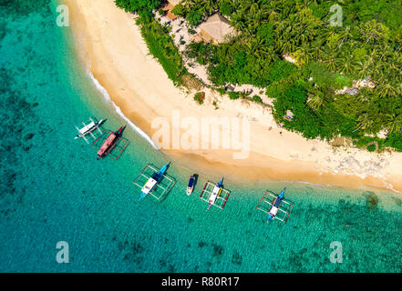 aerial view of Helicopter  island  beach  with traditional boats in Bacuit archipelago, Philippiunes