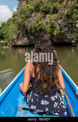 HPA-AN, MYANMAR - 19 NOVEMBER, 2018:  Vertical picture of young woman at the boat in the exterior of Sadan Cave in Hpa-An, Myanmar Stock Photo