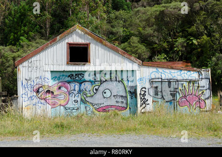 Graffiti on derelict barn, Mount Messenger, Taranaki, North Island, New Zealand Stock Photo