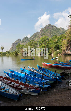 HPA-AN, MYANMAR - 19 NOVEMBER, 2018:  Vertical picture of beautiful nature outside Sadan Cave and some traditional boats in Hpa-An, Myanmar Stock Photo