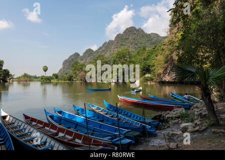 HPA-AN, MYANMAR - 19 NOVEMBER, 2018: Horizontal picture of the exterior of Sadan Cave and some traditional boats in Hpa-An, Myanmar Stock Photo