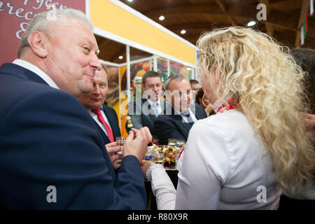 Belarus is the city of Gomel on October 25, 2018. Exhibition of products of national economy.Elderly man tasting alcohol Stock Photo