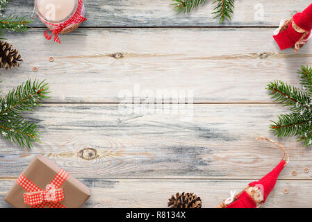 Christmas composition with fir branches, gifts and decorations on wooden table. Stock Photo