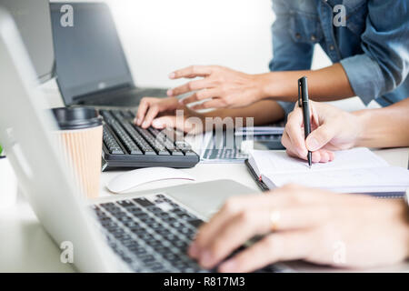Asian team Outsource Developer Looking Screen Programming Code Working with Laptop Computer Software Stock Photo