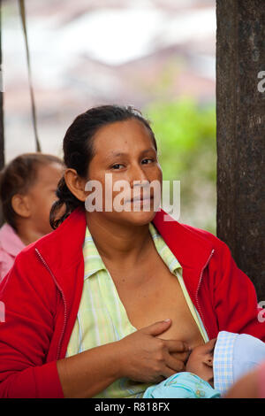 A mother breasting her infant at Belen market in Iquitos,Peru Stock Photo