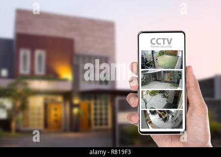 monitoring cctv via mobile phone app Stock Photo