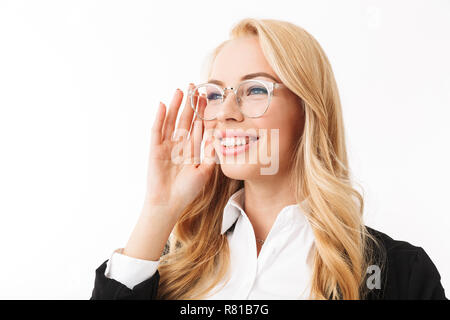 Photo of cheerful businesswoman wearing office suit and eyeglasses smiling while looking aside isolated over white background in studio Stock Photo