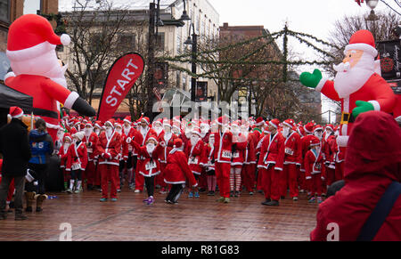 Burlington, Vermont / USA - December 2,2018:the start of  5 km race  for charity with runners dressed as Santa Claus on a wintry Sunday morning Stock Photo