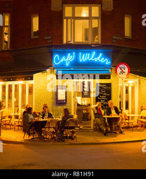 COPENHAGEN, DENMARK - JUNE 16, 2018: People at a street restaurant in Copenhagen. Copenhagen is the capital of Denmark