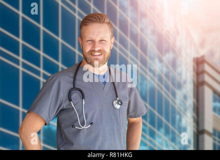 Caucasian Male Nurse In Front Of Hospital Building. Stock Photo