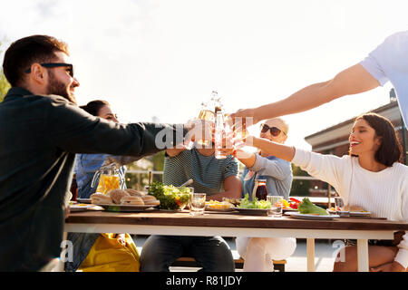 happy friends toasting drinks at rooftop party Stock Photo