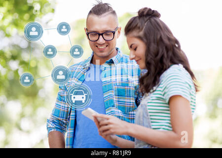 happy couple using car sharing app on smartphone Stock Photo