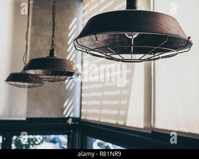 Vintage hanging lamps, lighting bulbs decoration in cafe. Retro style ceiling lights. Stock Photo