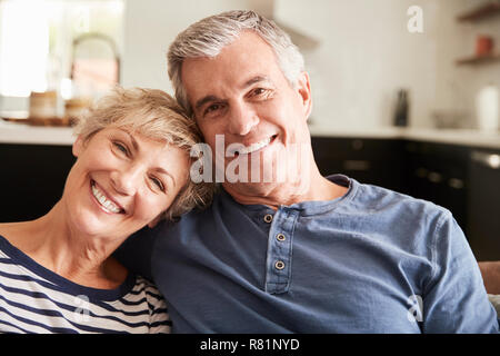 Senior couple relaxing at home smiling to camera, close up Stock Photo