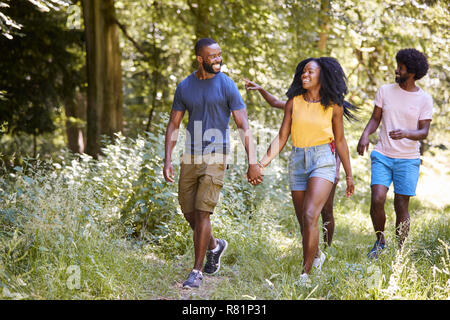 Two black couples walking together in woods Stock Photo