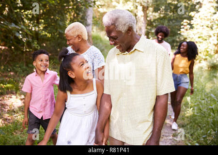 Multi generation black family walking in forest, close up Stock Photo