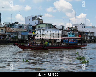 Tourist cruise boat taking tourists to visit Cai Be floating market on the iconic Mekong River Vietnam Asia Stock Photo
