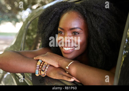 Young black woman looks out of the car window Stock Photo