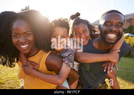 Black parents piggybacking their young kids, close up Stock Photo